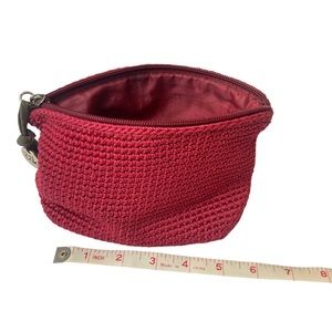The Sak maroon cosmetic toiletry zip bag with zip-pocket located inside the bag.